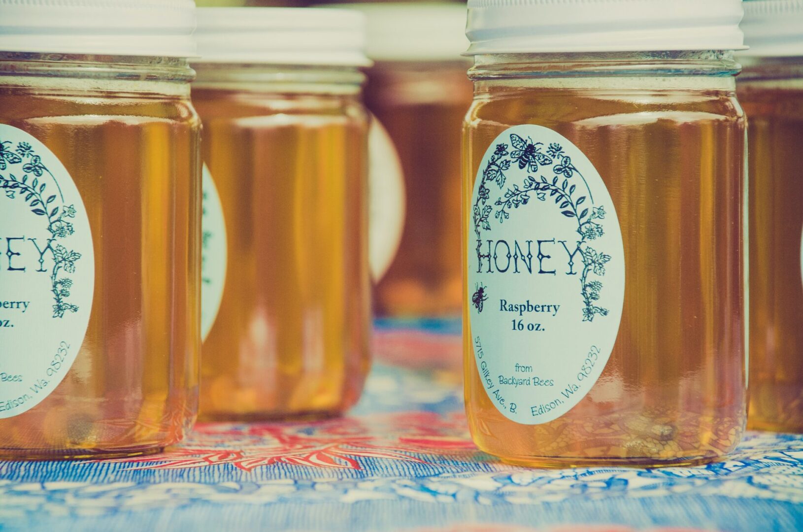 A close up of jars with honey on them